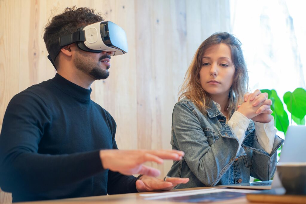 A man and woman engaged in a modern work environment using virtual reality technology.